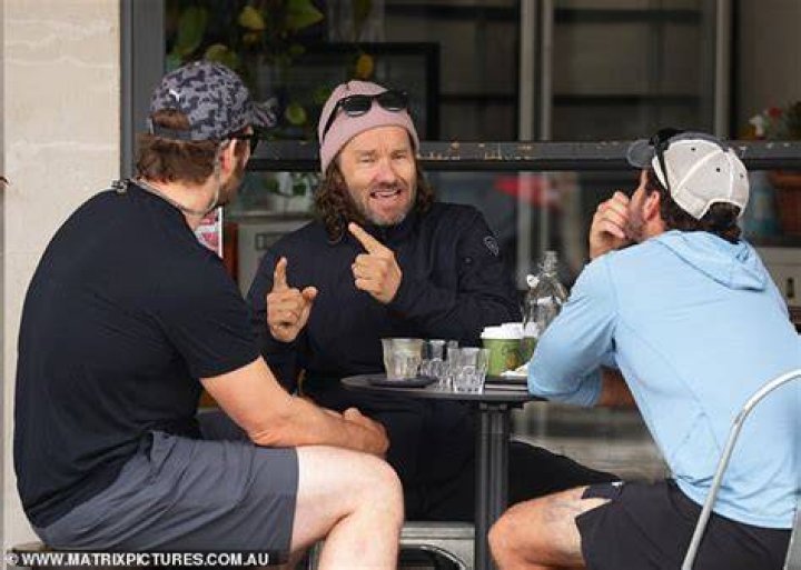 Cheerful chap: Joel, 46, was also sporting a fair bit of facial hair, and rugged up against the gloomy weather in a black wind-breaker